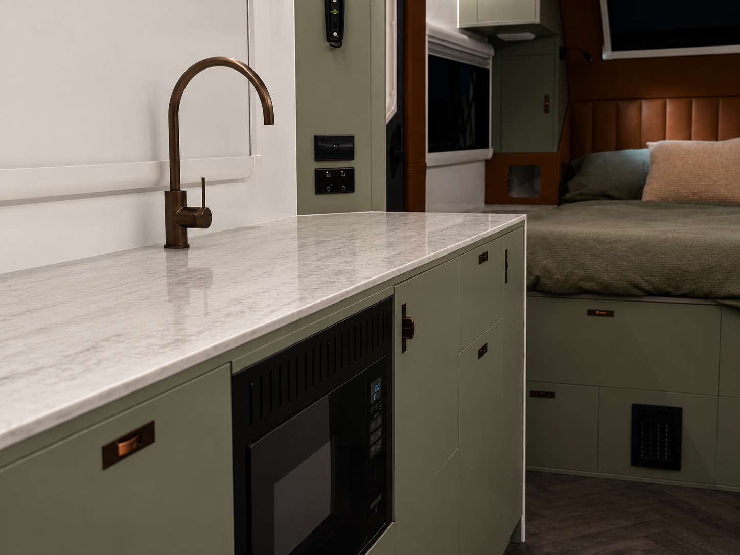 ADX-21 interior marble benchtop with brass tapware and leather bedhead beyond